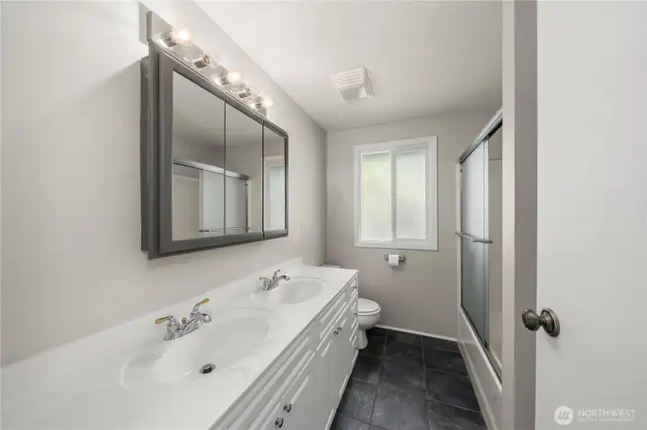 The updated full bathroom with double sinks and tub shower. The updated full bathroom with double sinks and tub shower.