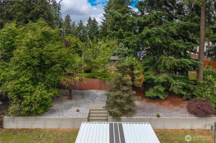 Terraced back yard has lots of lawn yet plenty of mature landscaping. Terraced back yard has lots of lawn yet plenty of mature landscaping.