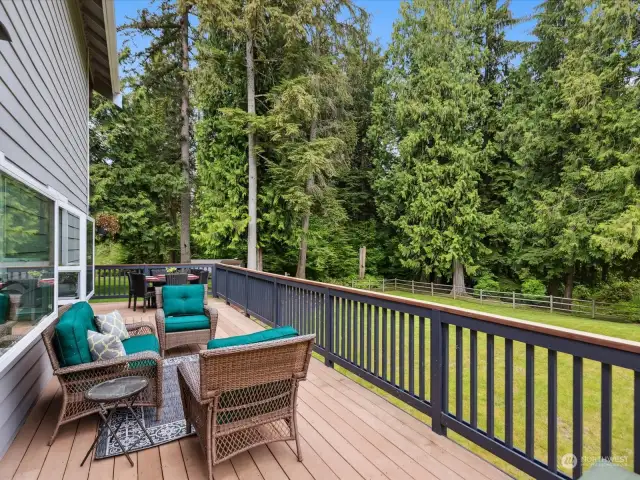 A wrap-around deck encircles the home, providing ample space for outdoor dining, lounging, and entertaining.