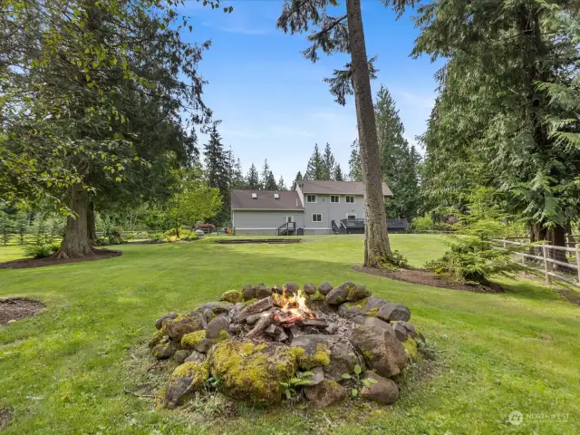 In the heart of the backyard, you'll find a cozy fire pit area, ideal for gathering with family and friends on cool evenings. Imagine roasting marshmallows, sharing stories, and creating lasting memories around the warm glow of the fire.