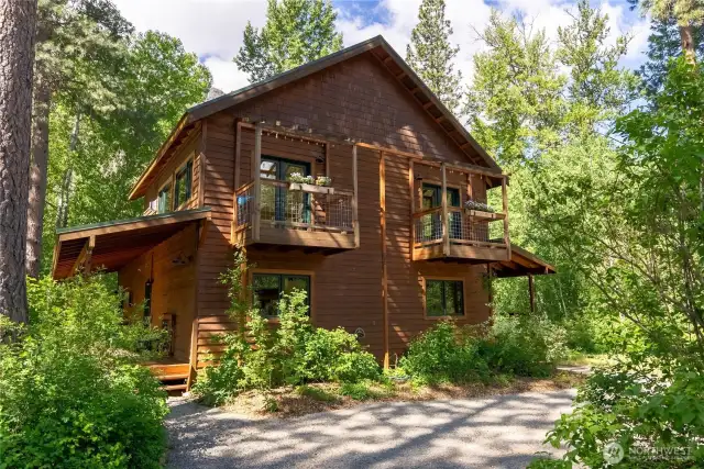 Beautiful 9.97-acre mountain retreat with forest, meadow, and mountain views. Backs to National Forest and is just steps from community trails. The 2,200 sq ft home features 3BD, 2BA, a spacious upstairs primary ensuite with balcony, and a versatile bonus room. The great room offers vaulted ceilings, skylights, and a wall of windows nestled in aspen trees with views of dramatic rock walls. Enjoy all-new appliances, wood floors, and a cozy propane stove. Outdoor living includes a large deck, screened porch, hot tub, and fenced backyard. The insulated garage offers a workshop, bathroom, kitchenette, and upper-level studio. A thoughtfully designed retreat with a peaceful, private setting and direct access to year-round recreation.