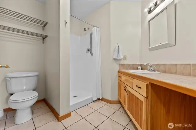 Main level bathroom with tile floors and walk-in shower.