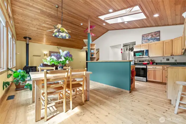 Vaulted wood ceilings with skylights fill the great room with light.