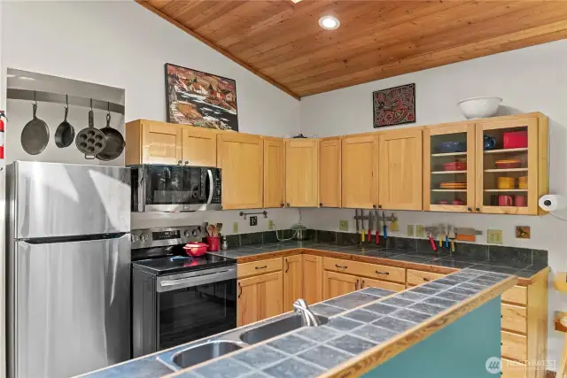 New stainless appliances and matching sink elevate the kitchen.