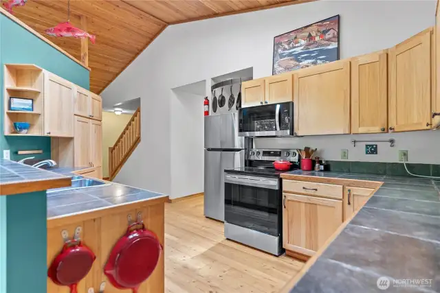 Hickory cabinetry and tile countertops blend warmth and function.