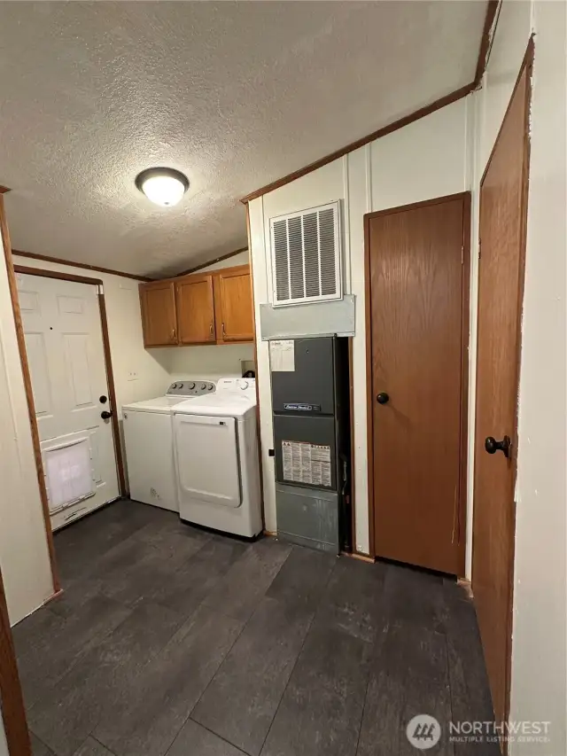Large laundry room with door to the back yard