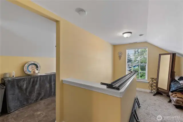 Upstairs landing peaking into the designated laundry area.