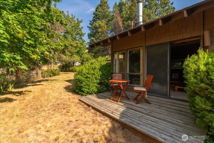 Patio among vast, green tree-rich surroundings