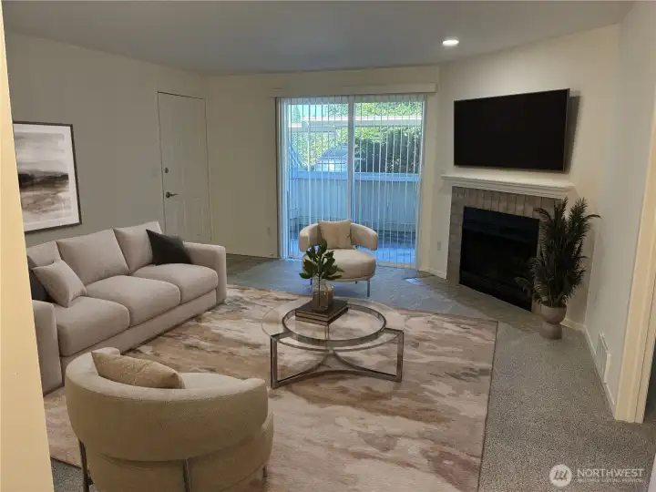 Sunny living room with slider to fenced patio and wood burning fireplace. Virtually staged.