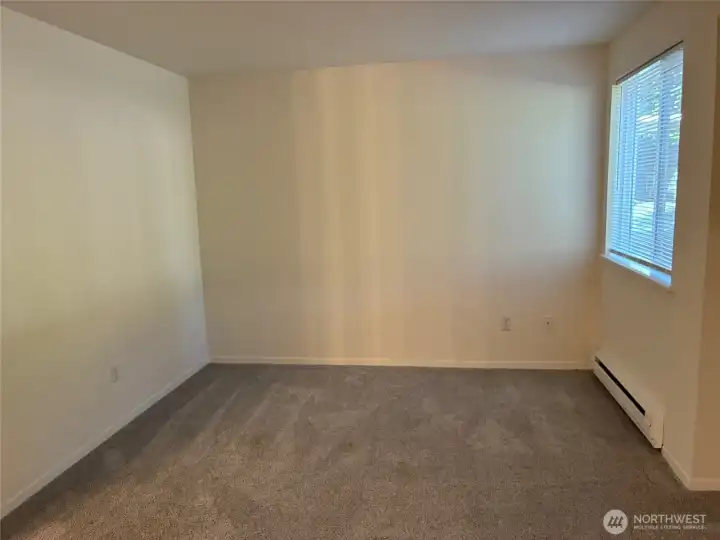 Spacious bedroom with open alcove/closet space.