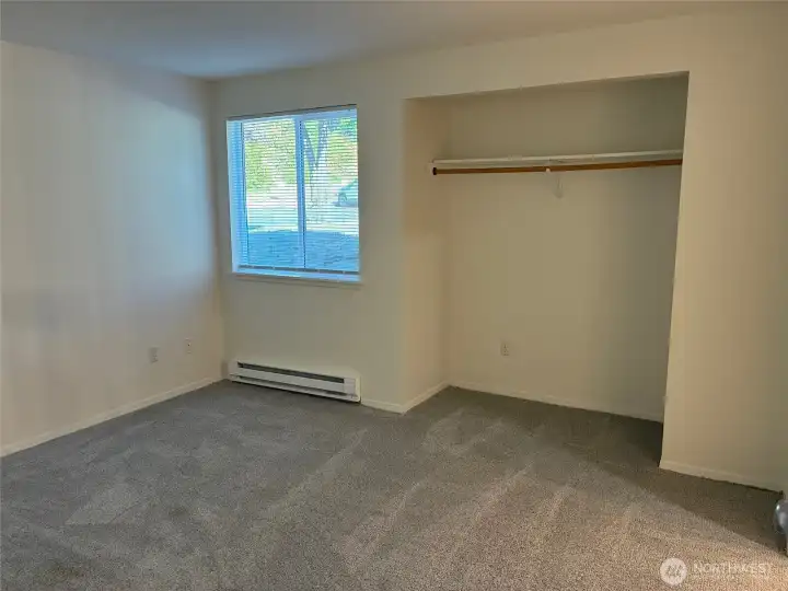 Spacious bedroom with open alcove/closet space.