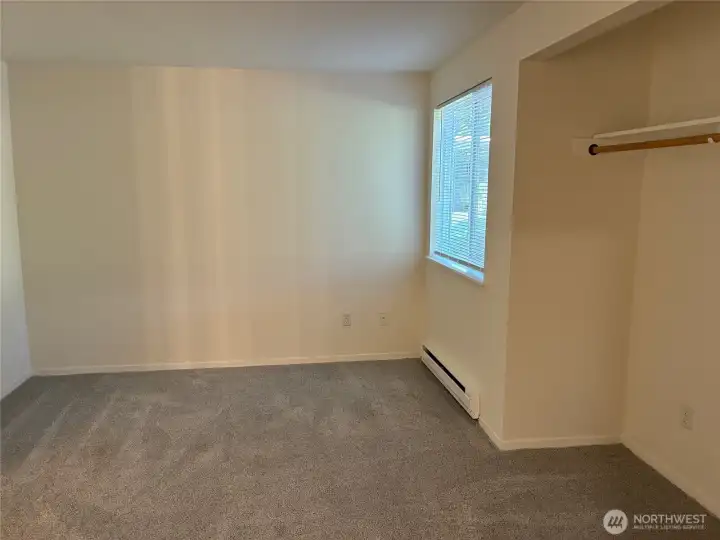 Spacious bedroom with open alcove/closet space.