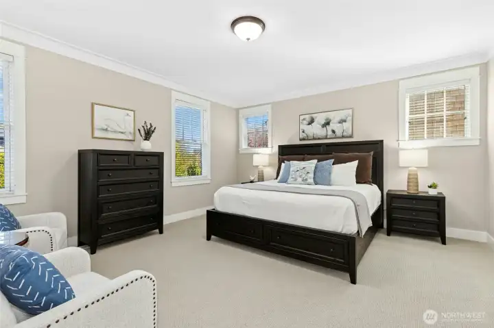 The second-floor primary bedroom features a king-size bed and plenty of space to unwind after a busy day at the beach.