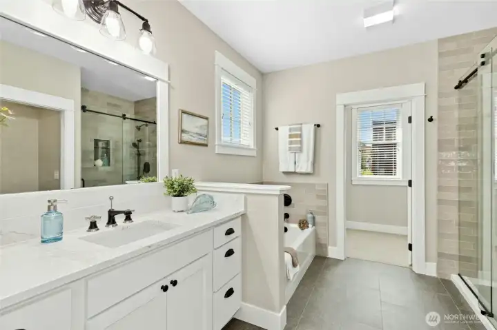 The primary en suite showcases gentle colors that bring a sense of calm - perfect for easing into or out of your day.