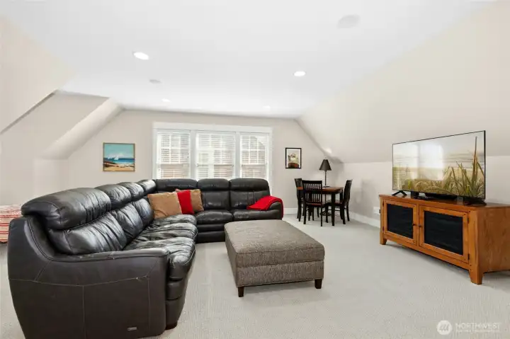 The third-floor loft offers a cozy spot to play, unwind, or watch a movie. Don't forget the popcorn!