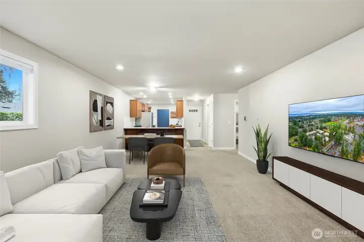 Bright, open living area with cozy fireplace and great natural light.  [Virtually staged photo]
