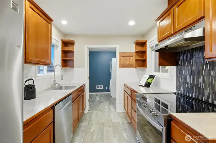 Spacious kitchen with abundant counter space and cabinetry for all your storage needs.  [Virtually staged photo]