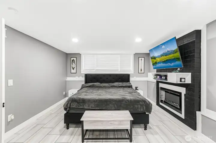 Picture of lower level rec/family room currently being used as a 4th bedroom. This beautiful fireplace has an electrical insert which can be converted easily into a wood burning fireplace as well.