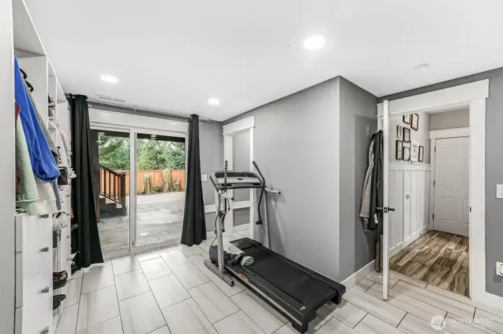 The other half of this rec/family room opens to a large covered patio area. 1st door opens to hallway entrance and hall entry by the slider leads to the walk-in closet and new 3/4 bath.