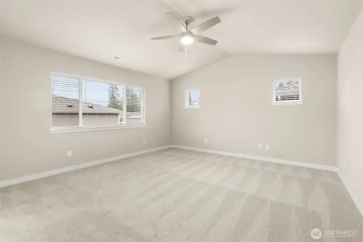 Primary bedroom with ceiling fan.