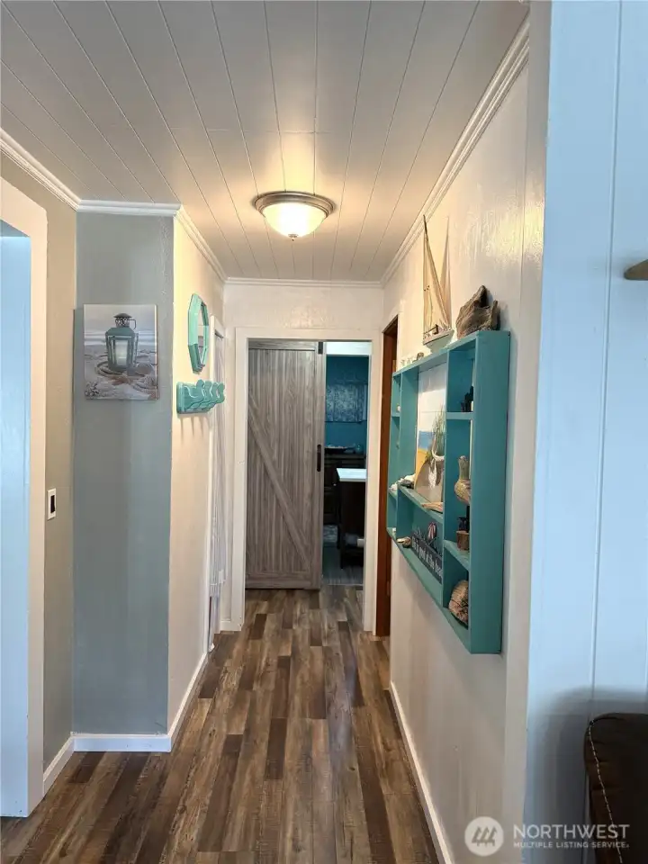 Hallway leads to three bedrooms and full bathroom.