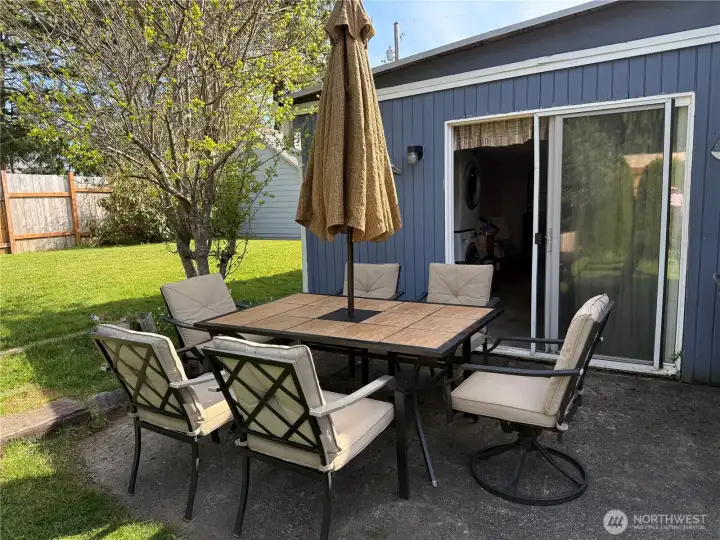 Patio with backyard and sliding door to bonus room.