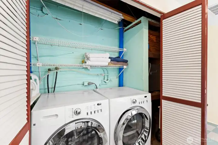 Convenient in-home laundry area with additional storage space.