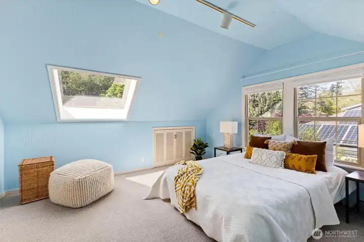 Expansive upstairs primary suite featuring skylight, built-ins, and ample flex space.