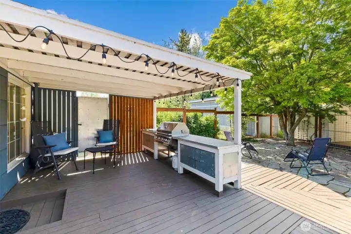 Covered outdoor entertaining space with room to relax, grill, and enjoy year-round gatherings.