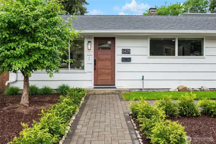 The paver sidewalk leads to the stylish entry from both the front sidewalk and driveway to the right.
