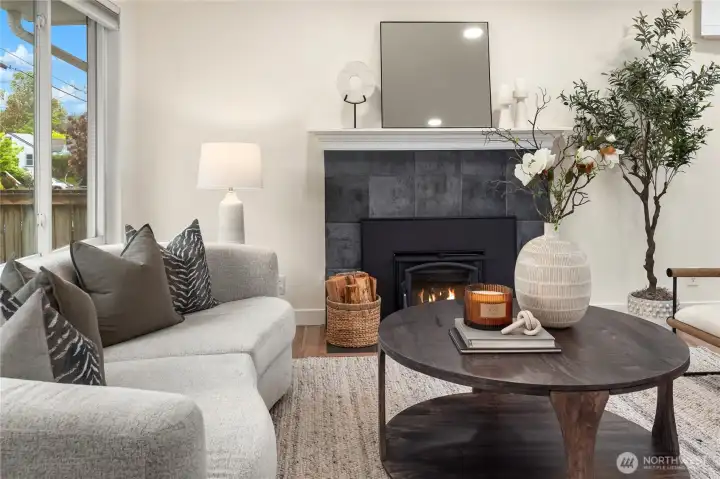 A beautifully tiled fireplace features a masonry chimney and firebox with a wood stove insert that will warm your soul.