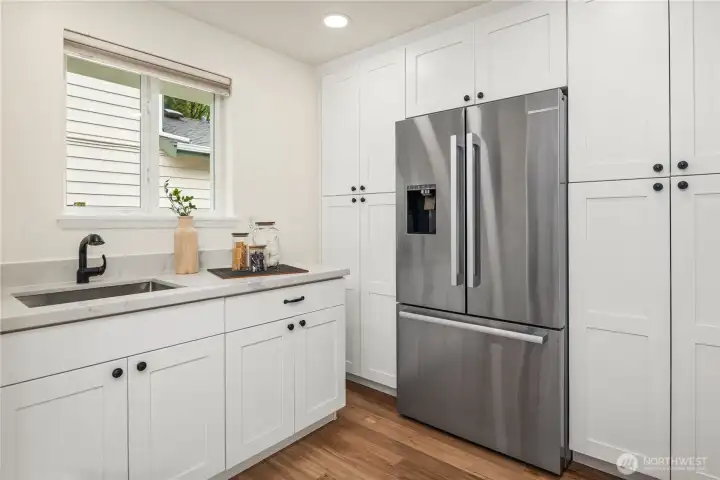 The oversized pantry area also features a second sink and more cabinetry.