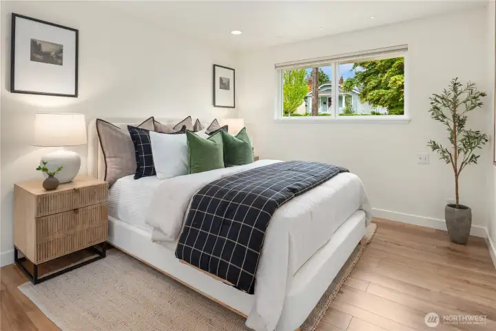 The primary bedroom easily handles a king sized bed and features an adjacent dressing room with 2 closets.
