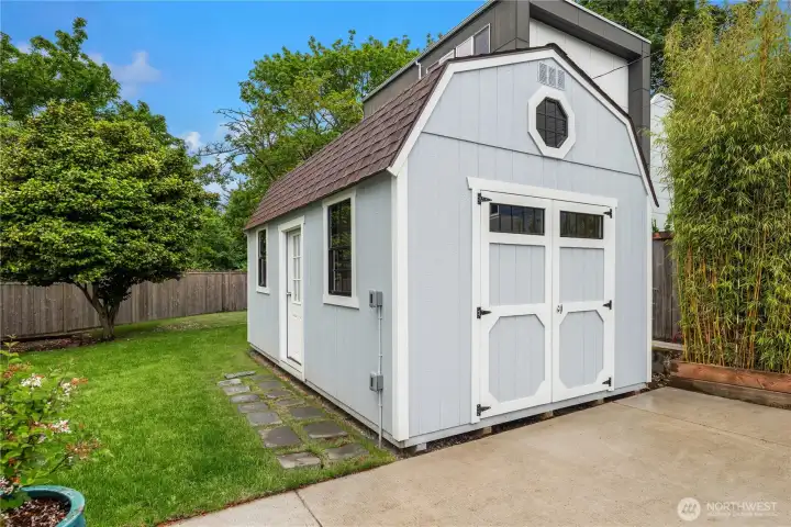 Just off the patio is this fully permitted outbuilding with multiple entrances.