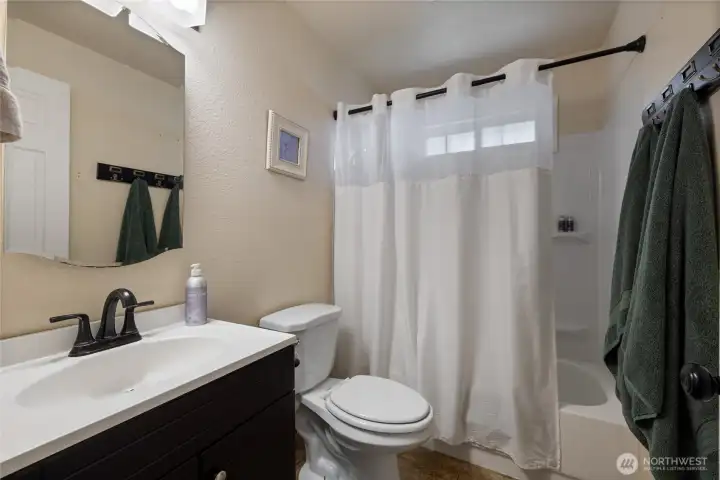 A full bath offering updated fixtures, natural light, and airflow from it's own window.