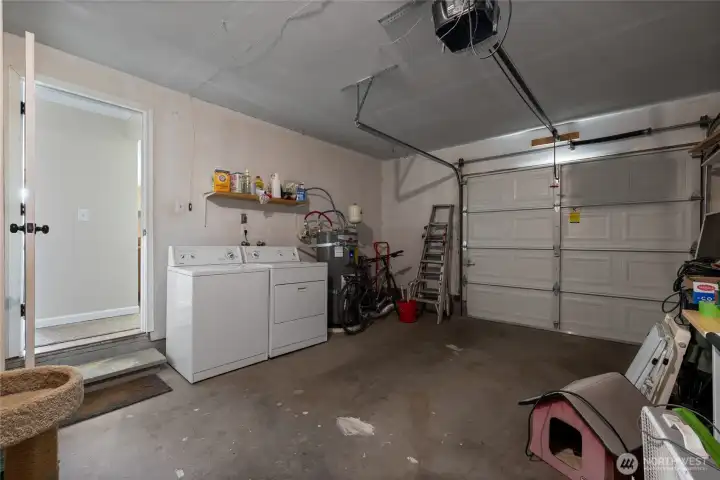 You'll find the washer and dryer in this single car garage, along with a separate exterior man door to the side yard.
