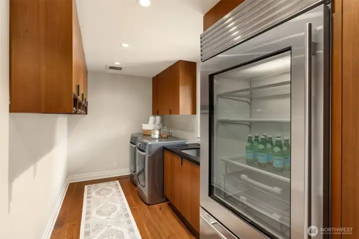 The pantry area features abundant storage space and includes a full-size Sub-Zero refrigerator.
