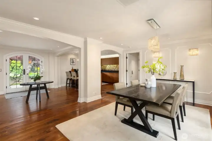 Dining area with an open-concept view of the kitchen and entryway.