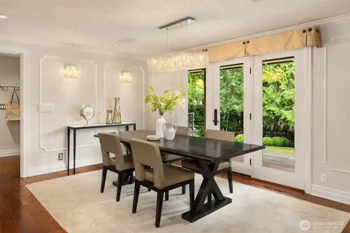 Double doors open from the dining area to a spacious ipe deck and custom flagstone patio, perfect for outdoor entertaining.