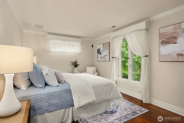 This guest bedroom faces south with views of the patio and pastures. It also has a walk in closet.