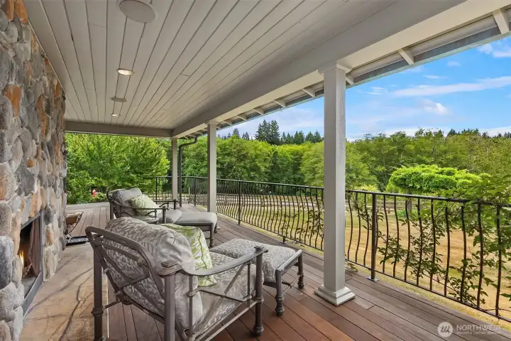 The west side deck serves as the ideal retreat to relax by the outdoor fireplace while enjoying scenic views of the rolling pastures.