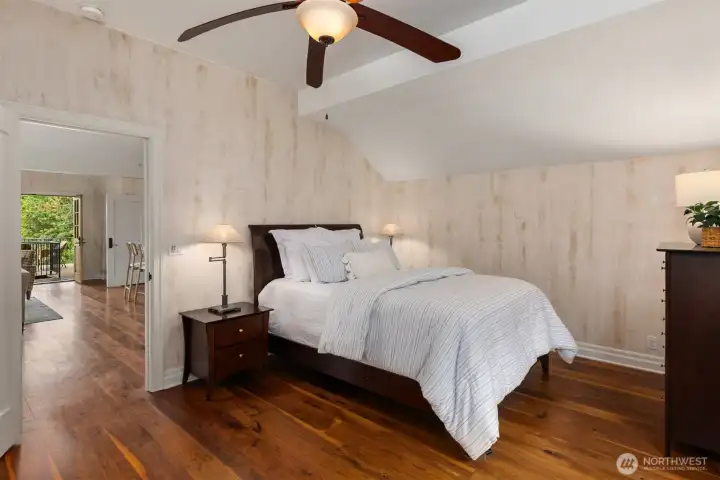 Spacious bedroom featuring large windows and extensive walk-in closet storage.