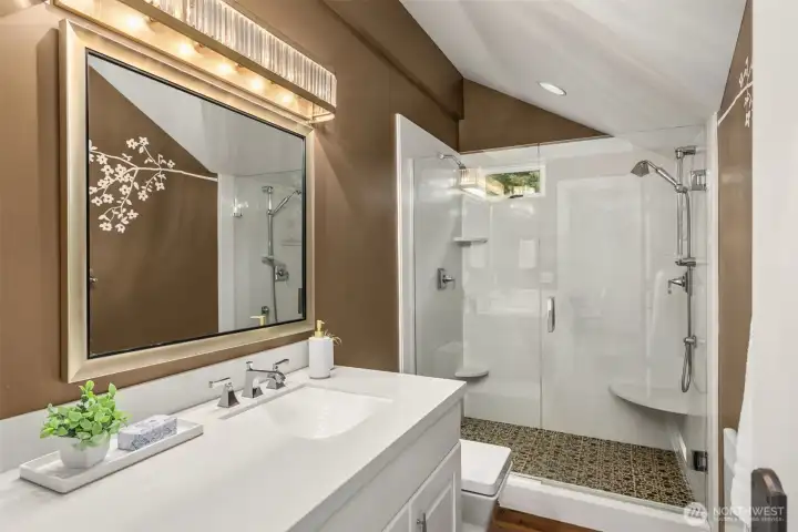 Guest house features a three-quarter bath, a spacious walk-in shower, and high-quality tile detailing throughout.