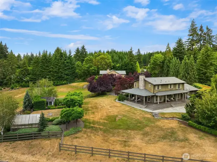 Exterior view looking north, featuring the main house, greenhouse, chicken coop, and accessory dwelling unit.
