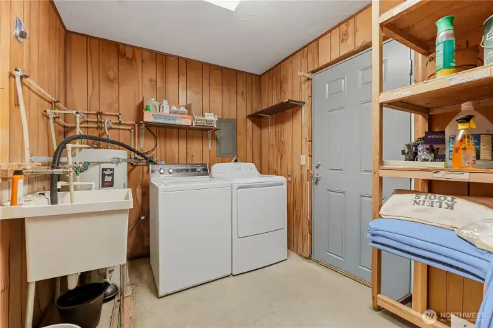 laundry room w storage space and separate hot water tank
