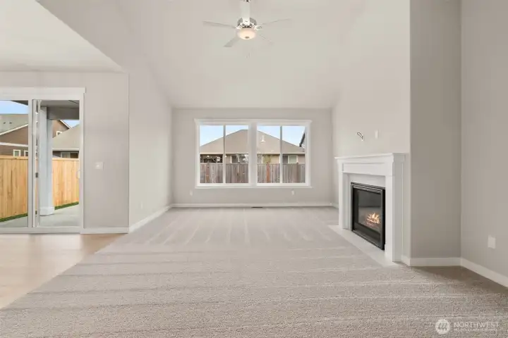 Light and bright living room with vaulted ceilings and a ceiling fan for added comfort Light and bright living room with vaulted ceilings and a ceiling fan for added comfort