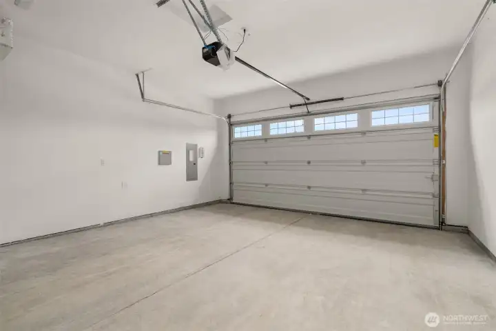 Garage features primed walls for more finished look and garage door opener Garage features primed walls for more finished look and garage door opener