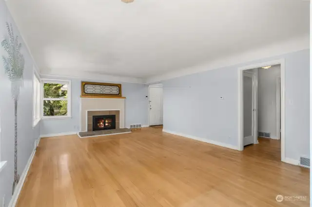 Living room features coved ceiling & hardwood floors