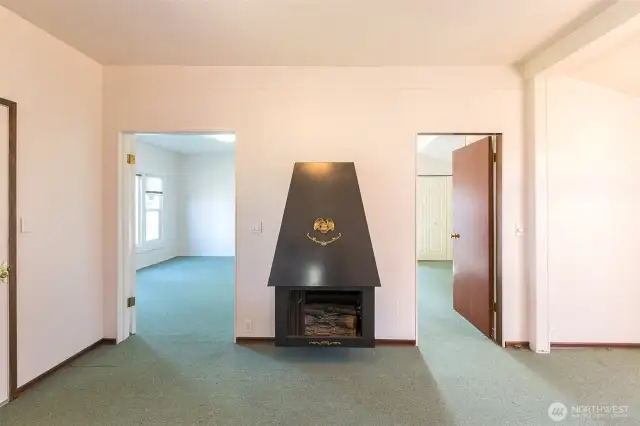 Electric Fireplace and Bedroom entrances.