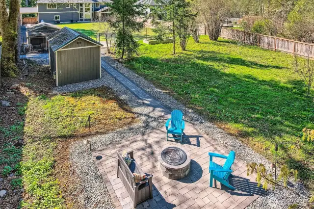 View of the rear-most portion of the property, known as the “Back 40.” Ideal for kids camping under nearby fruit trees and set apart for privacy, this peaceful area is great for stargazing or gathering around the firepit. A unique outdoor retreat designed for connection, relaxation, and memory-making.
